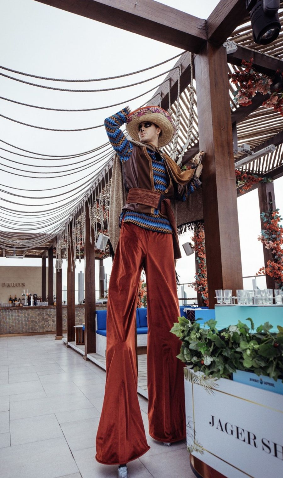 Stilt walker on the Paros rooftop at Creator Night